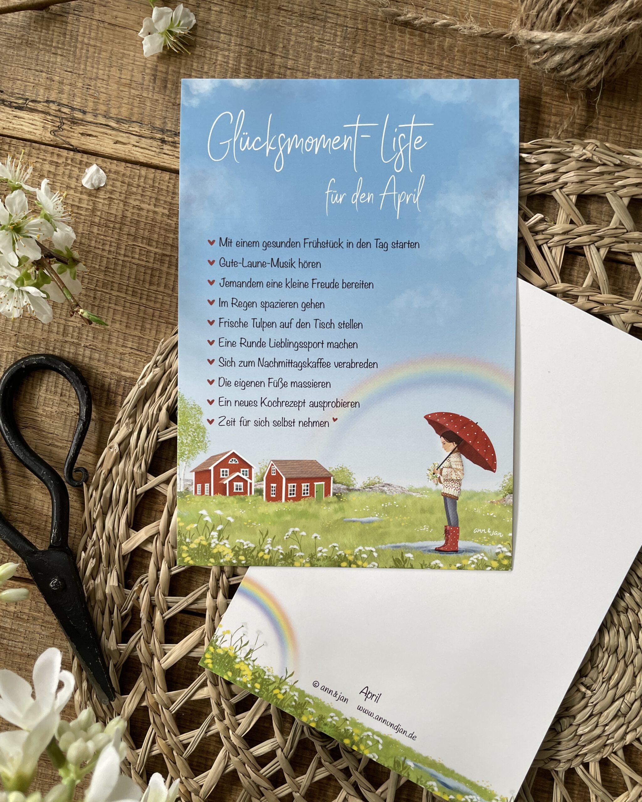 Handillustrierte große Postkarte Glücksmomente April Schwedenhäuser Mädchen Regenschirm Wiesenblumen Regenbogen von Ann und Jan