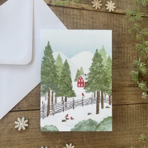 Handillustrierte Klappkarte Winterglück rotes Holzhaus verschneite Berglandschaft Gimpel Tannen von Ann und Jan Kuvert weiß