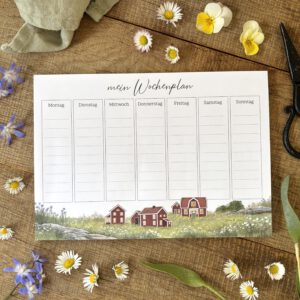 Handillustrierter Wochenplaner Ida mit skandinavischen roten Holzhäusern auf Blumenwiese von Ann und Jan