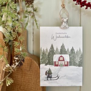 Postkarte Zauberhafte Weihnachten. Schwedenhaus mit Schlitten und Weihnachtsbaum in verschneiter Landschaft.